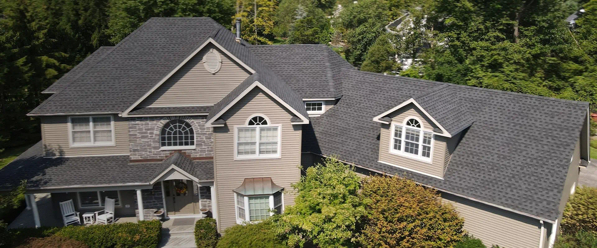 aerial view of a house with an asphalt shingle roof